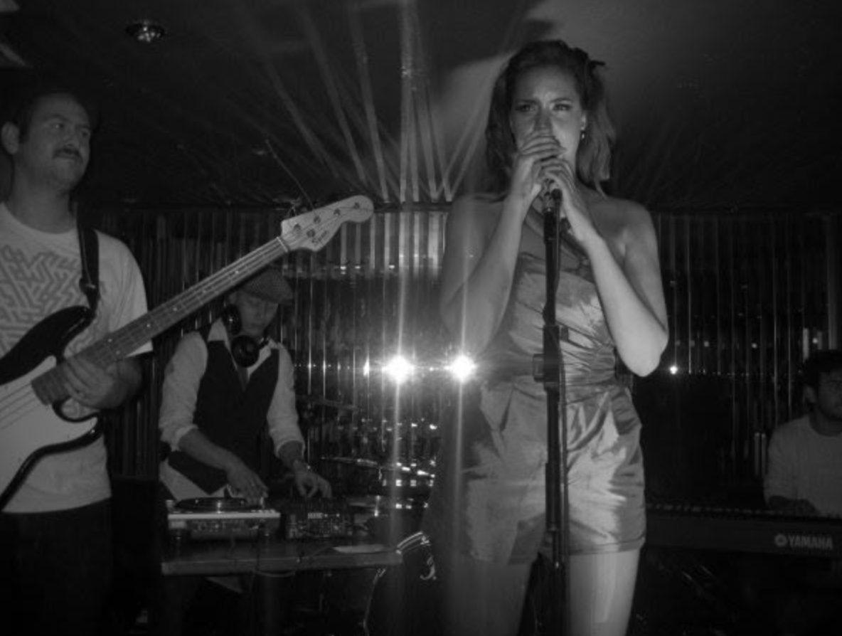 Black and white shot of the band and singer on stage