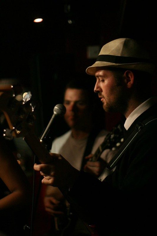 Bassist in a fedora at the mic