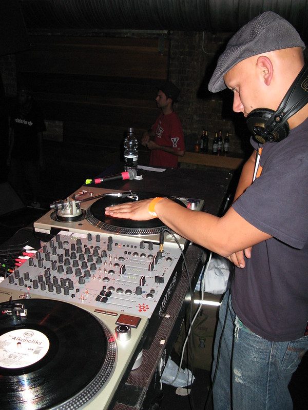 DJ with a hand on the platter