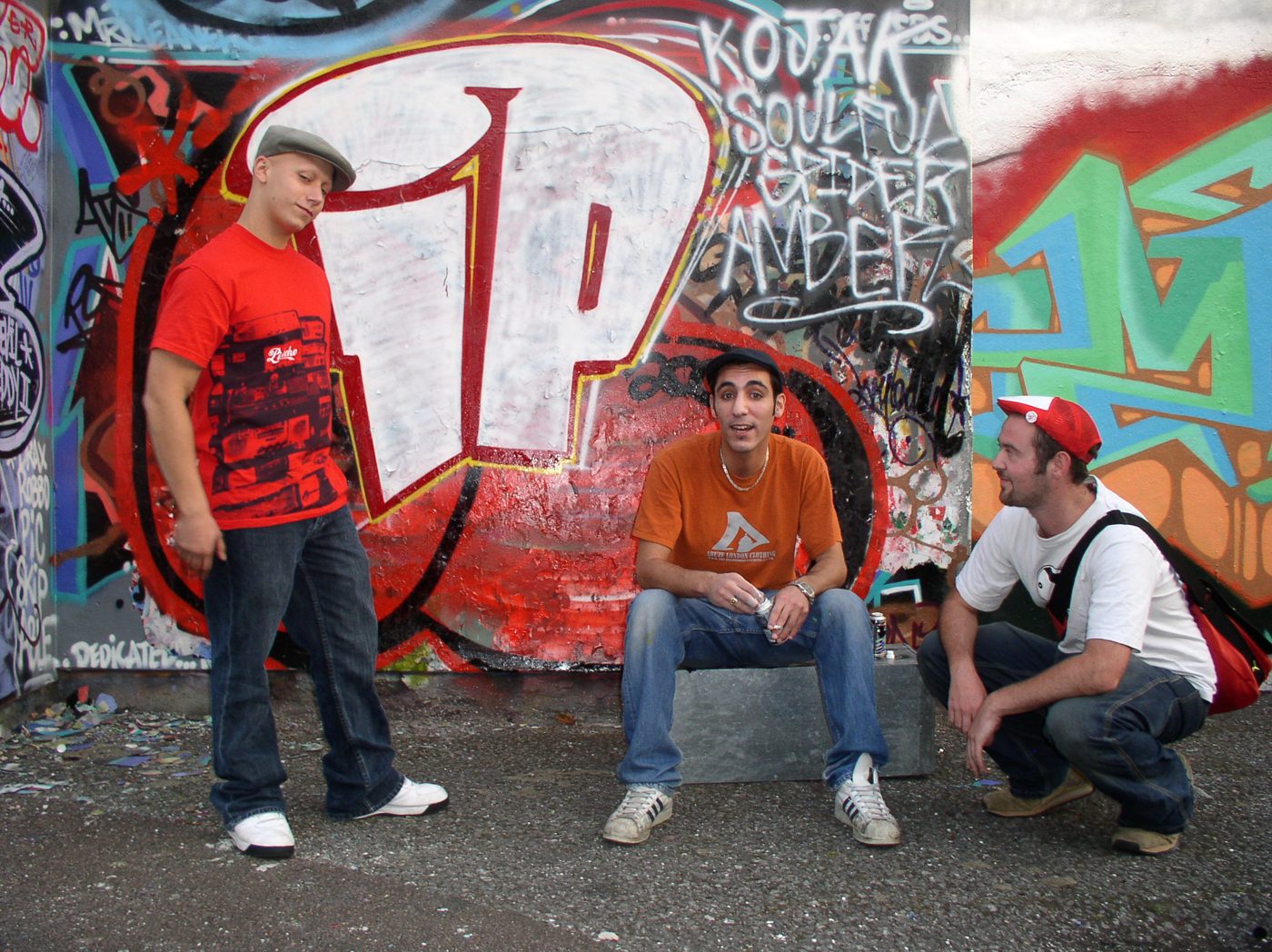 Three members of Infinite Potential at their IP graffiti wall, with Kojak, Soulful Spider and Amber tagged beside it