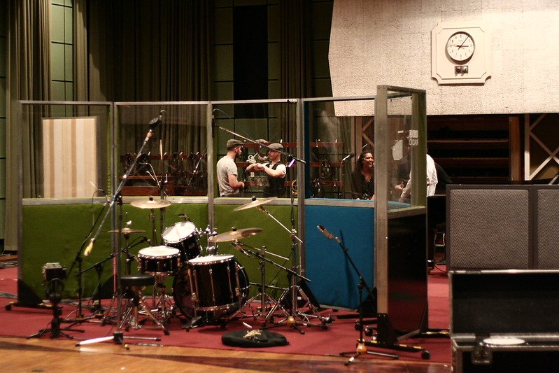 Drum kit and glass booths in a large studio room