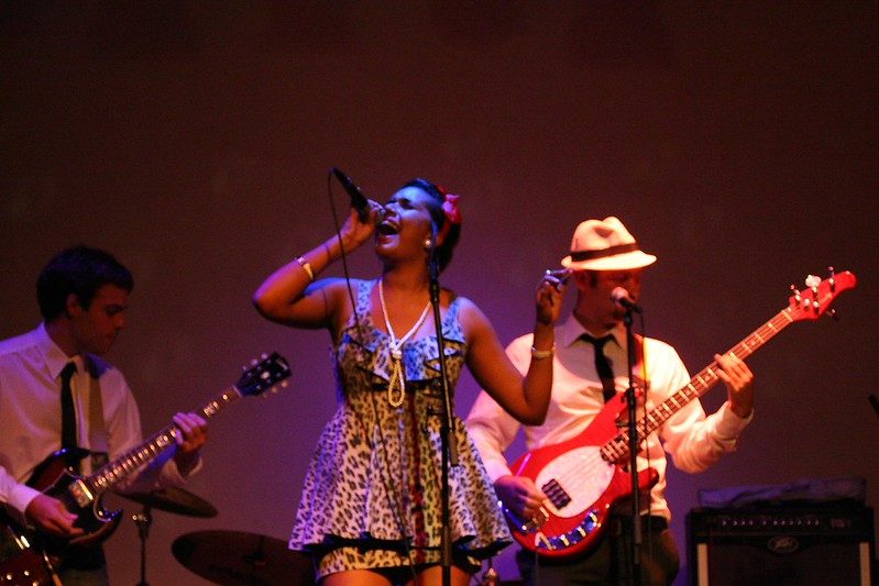 Singer fronting the band under purple light